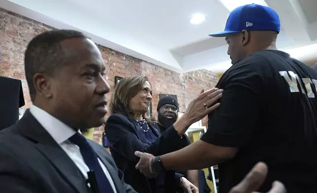 Democratic presidential nominee Vice President Kamala Harris, second left, is greeted upon arriving at Philly Cuts barbershop for a conversation with Black men, during a campaign stop, Sunday, Oct. 27, 2024, in Philadelphia. (AP Photo/Susan Walsh)