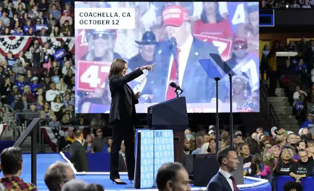 Democratic presidential nominee Vice President Kamala Harris speaks as an image of Republican presidential nominee former President Donald Trump appears on screen during a campaign rally at Erie Insurance Arena, in Erie, Pa., Monday, Oct. 14, 2024. (AP Photo/Jacquelyn Martin)