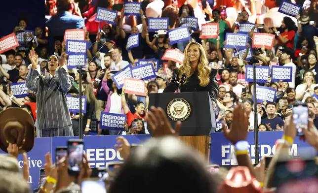 Musical artists Beyonce, right, and Kelly Rowland, left, on stage at a campaign event for Democratic presidential nominee Vice President Kamala Harris, Friday, Oct. 25, 2024, in Houston. (AP Photo/Annie Mulligan)