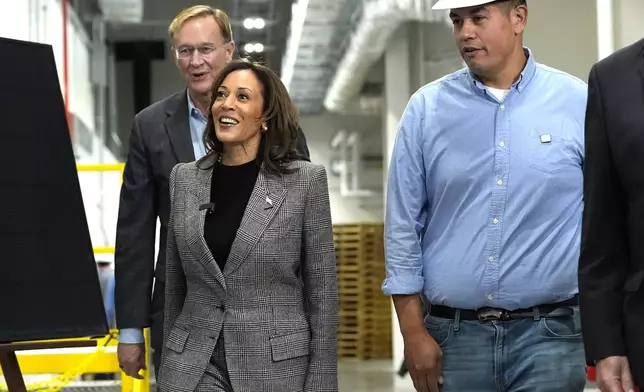 Democratic presidential nominee Vice President Kamala Harris, from second right, tours the Hemlock Semiconductor Next-Generation Finishing facility as Corning Chairman and CEO Wendell Weeks looks on, in Hemlock, Mich., Monday, Oct. 28, 2024. (AP Photo/Jacquelyn Martin)