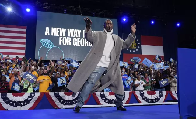 Grammy winning artist, Usher, reacts to the crowd during a campaign event for Democratic presidential nominee Vice President Kamala Harris at Lakewood Amphitheatre, Saturday, Oct. 19, 2024, in Atlanta. (AP Photo/Jacquelyn Martin)