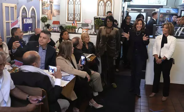 Philadelphia City Councilmember Quetcy Lozada, from right, Democratic presidential nominee Vice President Kamala Harris and Philadelphia Mayor Cherelle Parker visit Freddy and Tony's restaurant during a campaign stop, Sunday, Oct. 27, 2024, in Philadelphia. (AP Photo/Susan Walsh)