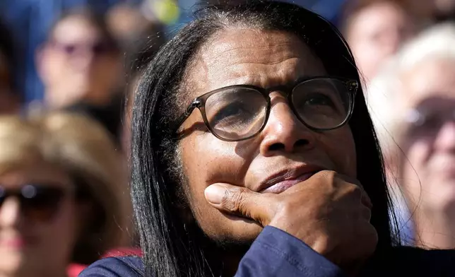 An attendee listens as Democratic presidential nominee Vice President Kamala Harris speaks during a campaign event at Riverside Park in Grand Rapids, Mich., Friday, Oct. 18, 2024. (AP Photo/Jacquelyn Martin)