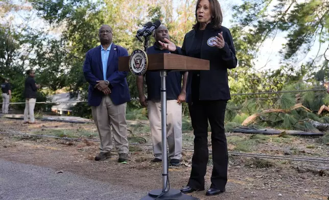 Democratic presidential nominee Vice President Kamala Harris speaks as she tours an area impacted by Hurricane Helene in Augusta, Ga., Wednesday, Oct. 2, 2024, as Augusta Mayor Garnett Johnson, left, and FEMA deputy administrator Erik Hooks listen. (AP Photo/Carolyn Kaster)