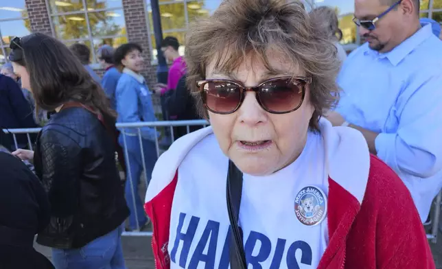 Joy Olson, of La Crosse, Wis., wearing a pin saying "Make America Joyful Again," speaks before a campaign event for Democratic presidential nominee Vice President Kamala Harris, Thursday, Oct. 17, 2024, at the University of Wisconsin La Crosse. (AP Photo/Steve Karnowski)