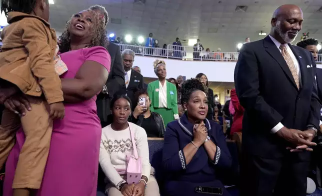 Attendees listen as Stevie Wonder performs "Redemption Song" during a church service and early vote event with Democratic presidential nominee Vice President Kamala Harris at Divine Faith Ministries International, Sunday, Oct. 20, 2024, in Jonesboro, Ga. (AP Photo/Jacquelyn Martin)