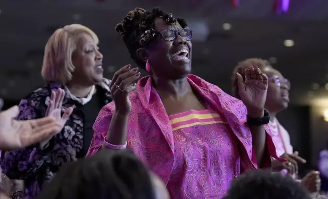 Attendees sing during a service at New Birth Baptist Church before democratic presidential nominee Vice President Kamala Harris speaks, in Stonecrest, Ga., Sunday, Oct. 20, 2024. (AP Photo/Jacquelyn Martin)