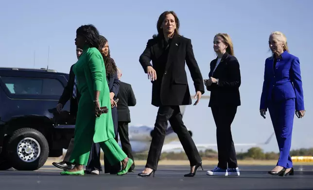 Democratic presidential nominee Vice President Kamala Harris arrives on Air Force Two in Philadelphia, Wednesday, Oct. 23, 2024. Harris was greeted by from left, Philadelphia Mayor Cherelle Parker (green), Harris, Rep. Madeleine Dean, D-Pa., (black), and Rep. Mary Gay Scanlon, D-Pa., (blue). (AP Photo/Matt Rourke)