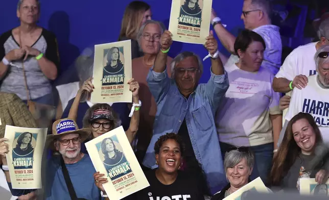 Attendees cheer before Democratic presidential nominee Vice President Kamala Harris arrives to speak during a campaign event at East Carolina University, Sunday, Oct. 13, 2024, in Greenville, N.C. (AP Photo/David Yeazell)