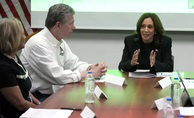 Democratic presidential nominee Vice President Kamala Harris, right, receives a briefing from North Carolina Gov. Roy Cooper on the damage from Hurricane Helene, Saturday, October 5, 2024 in Charlotte, N.C. (AP Photo/Chris Carlson)