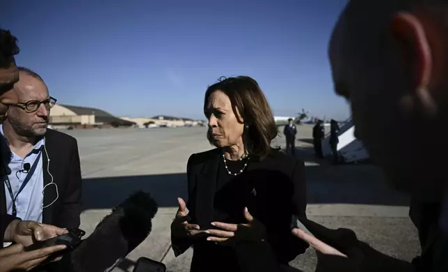 Democratic presidential nominee Vice President Kamala Harris talks to reporters before boarding Air Force Two, Wednesday, Oct. 30, 2024, at Joint Base Andrews, Md. (Brendan Smialowski/Pool via AP)