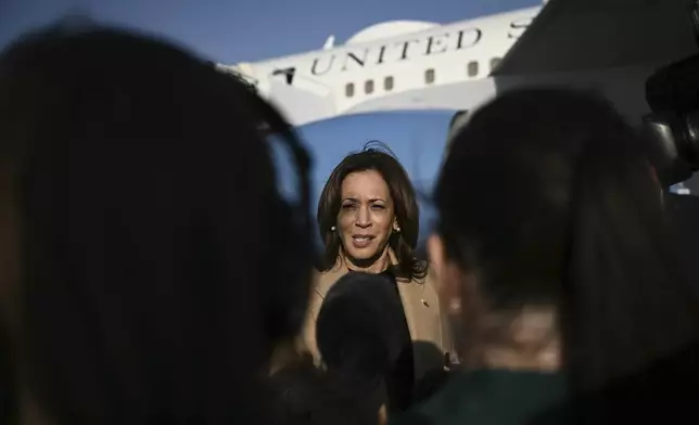 Democratic presidential nominee Vice President Kamala Harris speaks to the press before boarding Air Force Two at Joint Base Andrews, Md., Oct. 12, 2024, en route to North Carolina for a campaign event. (Brendan Smialowski/Pool via AP)