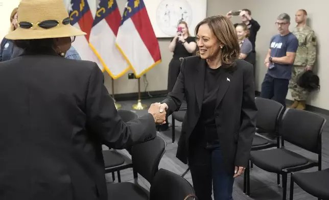 Democratic presidential nominee Vice President Kamala Harris, right, greets local officials after receiving a briefing on the damage from Hurricane Helene, Saturday, October 5, 2024 in Charlotte, N.C. (AP Photo/Chris Carlson)