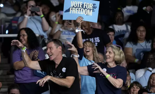 Attendees dance to the song "Thriller" before Democratic presidential nominee Vice President Kamala Harris arrives to speak at a campaign rally at East Carolina University in Greenville, N.C., Sunday, Oct. 13, 2024. (AP Photo/Susan Walsh)