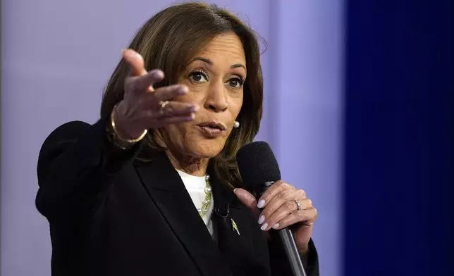 Democratic presidential nominee Vice President Kamala Harris speaks during a CNN town hall in Aston, Pa., Wednesday, Oct. 23, 2024, as moderator Anderson Cooper listens. (AP Photo/Matt Rourke)