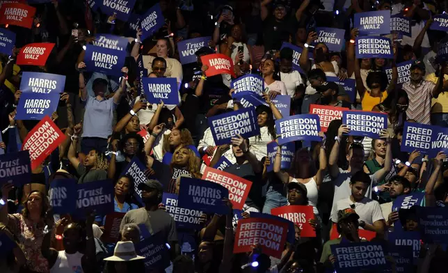 Attendees hold signs at a campaign rally for Democratic presidential nominee Vice President Kamala Harris, Friday, Oct. 25, 2024, in Houston. (AP Photo/Annie Mulligan)