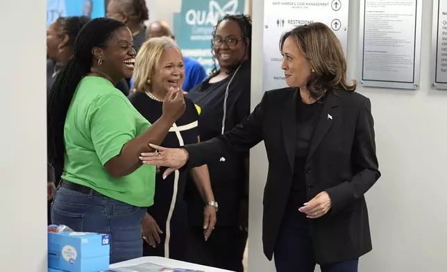 Democratic presidential nominee Vice President Kamala Harris, from right, greets Charlotte, N.C. Mayor Vi Lyles and Stacey Carless at a food drop-off and distribution center after receiving a briefing on the damage from Hurricane Helene, Saturday, October 5, 2024 in Charlotte, N.C. (AP Photo/Chris Carlson)