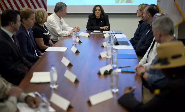 Democratic presidential nominee Vice President Kamala Harris, center right, receives a briefing from North Carolina Gov. Roy Cooper, center left, on the damage from Hurricane Helene, Saturday, October 5, 2024, in Charlotte, N.C. (AP Photo/Chris Carlson)