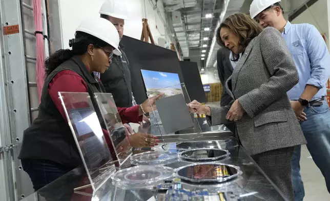 Democratic presidential nominee Vice President Kamala Harris, right, tours the Hemlock Semiconductor Next-Generation Finishing facility in Hemlock, Mich., Monday, Oct. 28, 2024. (AP Photo/Jacquelyn Martin)