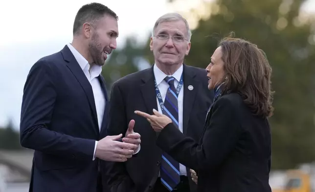 Pennsylvania state House Rep. Ryan Bizzarro, D-Erie, from left, and Erie, Pa. Mayor Joe Schember greet Democratic presidential nominee Vice President Kamala Harris as she arrives at Erie International Airport, in Erie, Pa., Monday, Oct. 14, 2024, to attend a campaign rally. (AP Photo/Jacquelyn Martin)