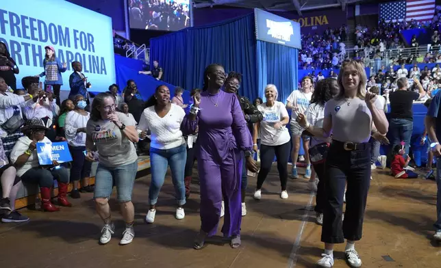 Attendees dance before Democratic presidential nominee Vice President Kamala Harris arrives to speak at a campaign rally at East Carolina University in Greenville, N.C., Sunday, Oct. 12, 2024. (AP Photo/Susan Walsh)