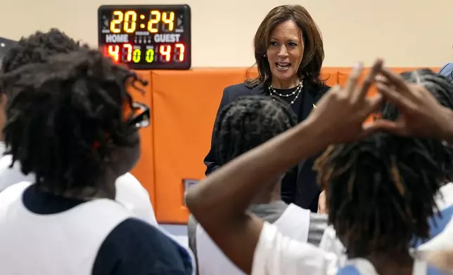 Democratic presidential nominee Vice President Kamala Harris speaks with young basketball players during a practice before a community rally at the Alan Horwitz "Sixth Man" Center, Sunday, Oct. 27, 2024, in Philadelphia. (AP Photo/Susan Walsh)