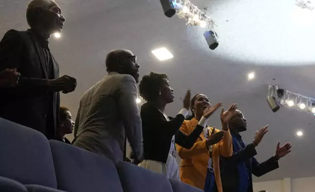 Attendees sing before Democratic presidential nominee Vice President Kamala Harris arrives to speak during a church service at Koinonia Christian Center in Greenville, N.C., Sunday, Oct. 13, 2024. (AP Photo/Susan Walsh)