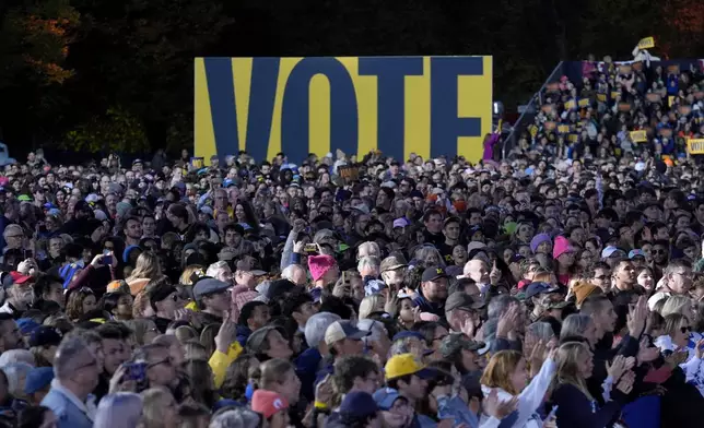 A crowd listens during a campaign rally for Democratic presidential nominee Vice President Kamala Harris in Burns Park, Monday, Oct. 28, 2024, in Ann Arbor, Mich. (AP Photo/Paul Sancya)