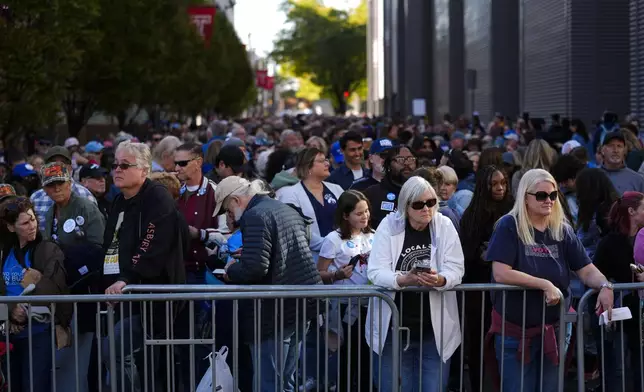 People wait in line to attend a rally with former President Barack Obama speaking in support of democratic presidential nominee Vice President Kamala Harris,, Monday, Oct. 28, 2024, in Philadelphia. (AP Photo/Matt Rourke)