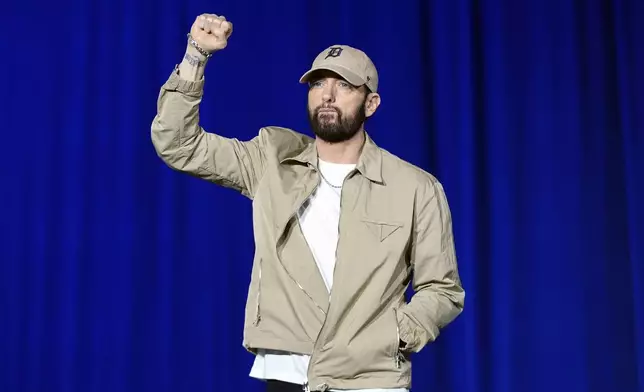 Rapper Eminem arrives to speak before former President Barack Obama at a campaign rally supporting Democratic presidential nominee Vice President Kamala Harris, Tuesday, Oct. 22, 2024, in Detroit. (AP Photo/Paul Sancya)