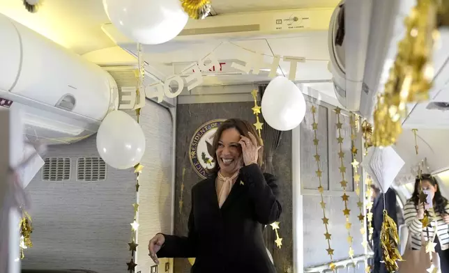 Democratic presidential nominee Vice President Kamala Harris reacts as she is surprised by campaign staff with birthday decorations on Air Force Two before departing Hartsfield Jackson International Airport in Atlanta, Sunday, Oct. 20, 2024, en route to Philadelphia. (AP Photo/Jacquelyn, Martin, Pool)