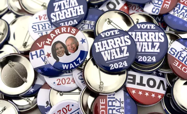 Campaign pins for sale are pictured before a campaign rally for Democratic presidential nominee Vice President Kamala Harris at the Dort Financial Center in Flint, Mich., Friday, Oct. 4, 2024. (AP Photo/Carolyn Kaster)