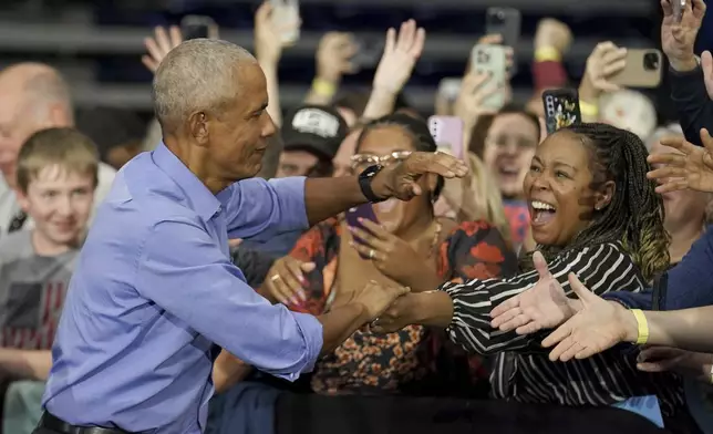 Former President Barack Obama greets attendees before speaking at a campaign rally supporting Democratic presidential nominee Vice President Kamala Harris, Thursday, Oct. 10, 2024, at the University of Pittsburgh's Fitzgerald Field House in Pittsburgh. (AP Photo/Matt Freed)