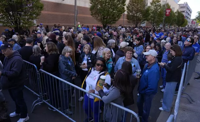 People wait in line to attend a rally with former President Barack Obama speaking in support of democratic presidential nominee Vice President Kamala Harris,, Monday, Oct. 28, 2024, in Philadelphia. (AP Photo/Matt Rourke)