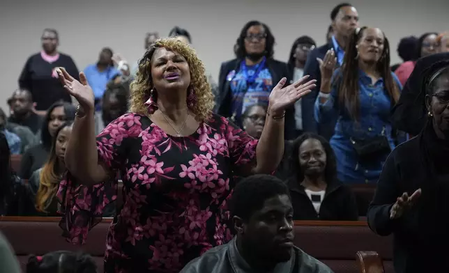 Members of the congregation pray before Democratic presidential nominee Vice President Kamala Harris arrives to speak during a service at the Church of Christian Compassion, Sunday, Oct. 27, 2024. (AP Photo/Susan Walsh)