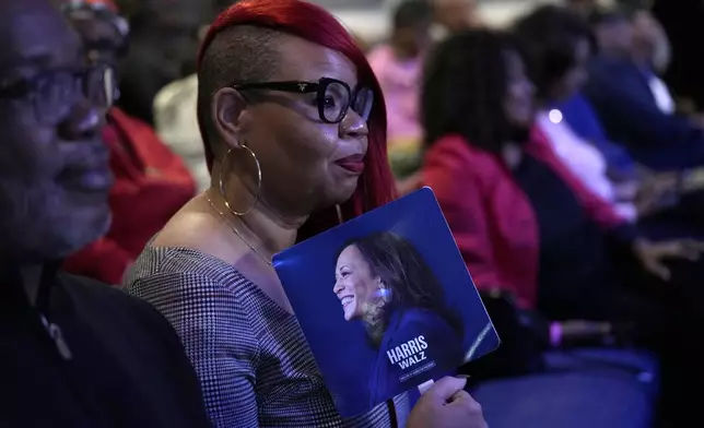 An attendee holds a campaign fan before Democratic presidential nominee Vice President Kamala Harris arrives to speak during a church service and early vote event at Divine Faith Ministries International, Sunday, Oct. 20, 2024, in Jonesboro, Ga. (AP Photo/Jacquelyn Martin)