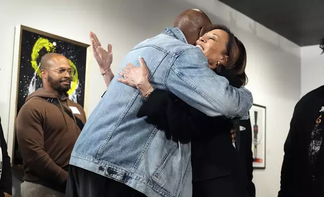 Democratic presidential nominee Vice President Kamala Harris hugs Delroy Lindo, left, at Norwest Gallery of Art in Detroit, Tuesday, Oct. 15, 2024. (AP Photo/Jacquelyn Martin)