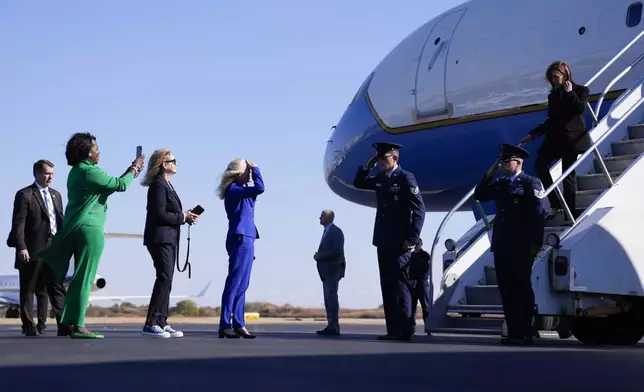 Democratic presidential nominee Vice President Kamala Harris arrives on Air Force Two in Philadelphia, Wednesday, Oct. 23, 2024, and is greeted by from left, Philadelphia Mayor Cherelle Parker (green), Rep. Madeleine Dean, D-Pa., (black), and Rep. Mary Gay Scanlon, D-Pa., (blue). (AP Photo/Matt Rourke)