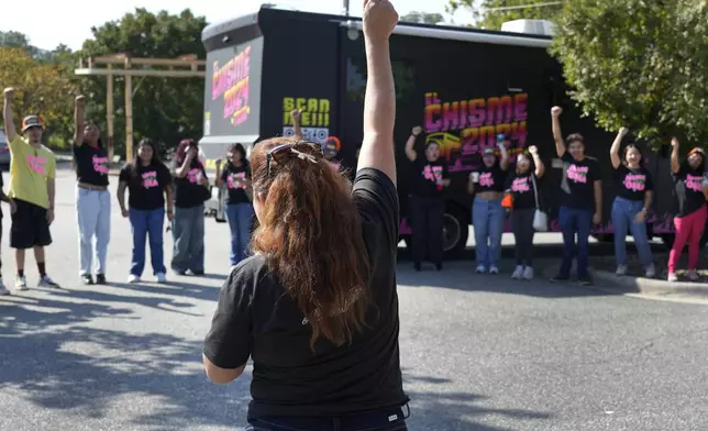 A group leader leads the team in a cheer during a voter engagement event for the Latino community in Greensboro, N.C., Saturday, Sept. 21, 2024. (AP Photo/Chuck Burton)