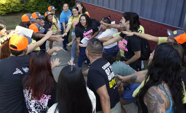 Members of a Latino support group celebrate as they meet together during a voter engagement event for the Latino community in Greensboro, N.C., Saturday, Sept. 21, 2024. (AP Photo/Chuck Burton)