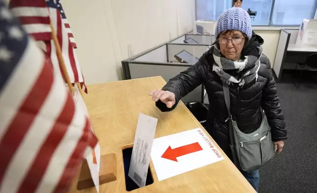 Judy Hemingson, of Des Moines, Iowa, casts her ballot during early voting at the Polk County Election Office, Wednesday, Oct. 16, 2024, in Des Moines, Iowa. (AP Photo/Charlie Neibergall)