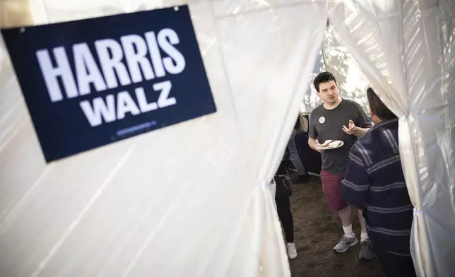 Adam Chaikof from Arlington, Va meets with other Kamala Harris supporters in a Sukkot in Bala Cynwyd, Pa on Sunday, Oct. 20, 2024. (AP Photo/Laurence Kesterson)