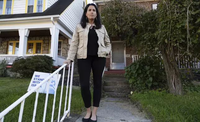 Rona Kaufman, a self-described progressive who is conflicted over who she will vote for in the presidential election, poses for a portrait outside her home in Squirrel Hill, a heavily Jewish neighborhood in Pittsburgh, Saturday, Oct. 20, 2024. (AP Photo/Rebecca Droke)