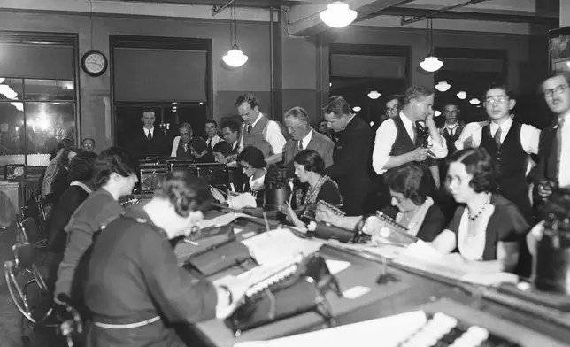 FILE - Workers at the Associated Press office in New York are shown busy at work on Election night, Nov. 8, 1932. (AP Photo, File)