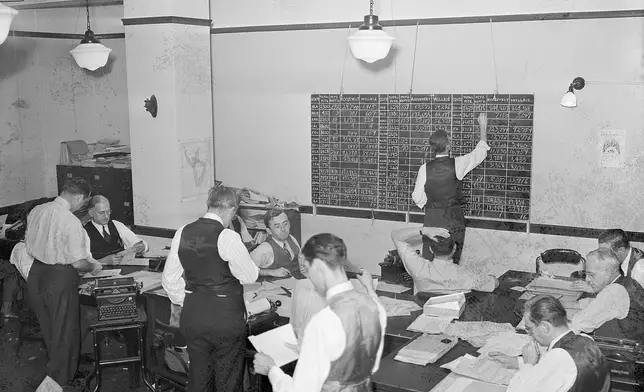 FILE - In this Nov. 5, 1940, file photo, Associate Press journalists in the Washington bureau tabulate election returns, keeping the score on both electoral and popular votes for the nation. (AP Photo/File)