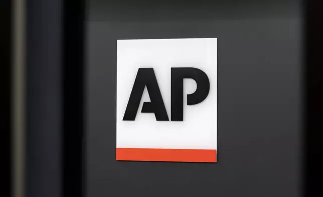 FILE - The Associated Press logo is displayed at the company's headquarters on April 18, 2017, in New York. (AP Photo/Jenny Kane, File)