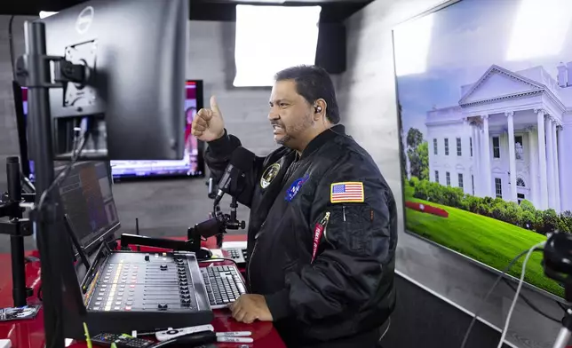 Radio host and owner of radio station La Mega 101.7 FM Victor Martinez on the air in Allentown, Pa., Tuesday, Oct. 15, 2024. (AP Photo/Ryan Collerd)