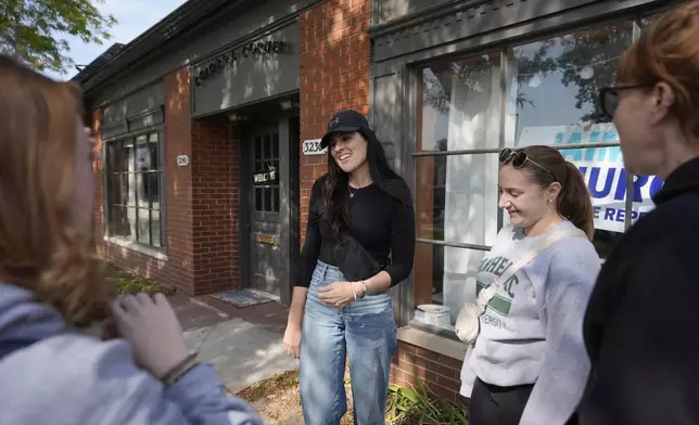 Democratic state Rep. Jaime Churches meets with volunteers, Friday, Oct. 11, 2024, in Trenton, Mich. (AP Photo/Carlos Osorio)