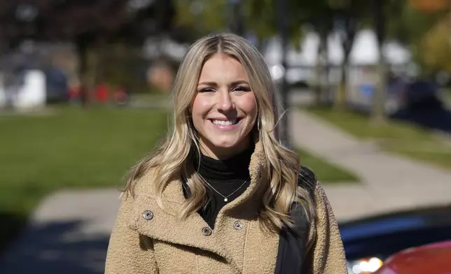 Republican Rylee Linting goes door to door campaigning hoping to unseat Democratic State Rep. Jaime Churches, Wednesday, Oct. 16, 2024, in Gibraltar, Mich. (AP Photo/Carlos Osorio)