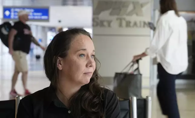 Lindsay Ruck, a server at Phoenix Sky Harbor International Airport restaurants, pauses in Terminal 3 as she works for minimum wage plus tips and is interested in the upcoming election and the Arizona Prop 138 on minimum wage vote Thursday, Oct. 3, 2024, in Phoenix. (AP Photo/Ross D. Franklin)